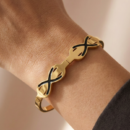 Gold Tone Infinity Knot Bangle – Black Enamel Accent Figure 8 Hinged Cuff Bracelet – Modern Symbolic Love Jewelry Gift for Her